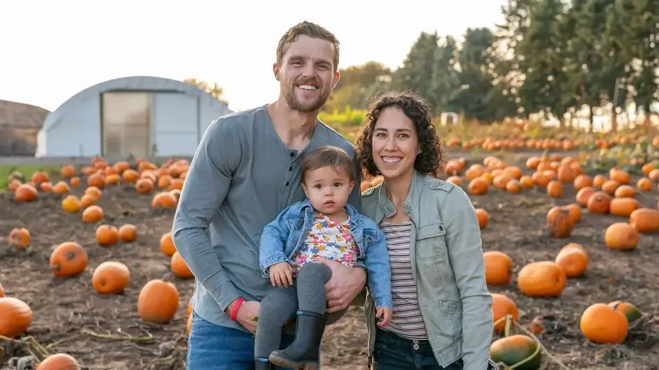 Adorable family at the pumpkin patch enjoying fall weather