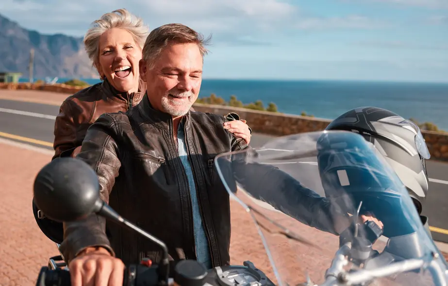 Retired couple enjoying a motorcycle ride together