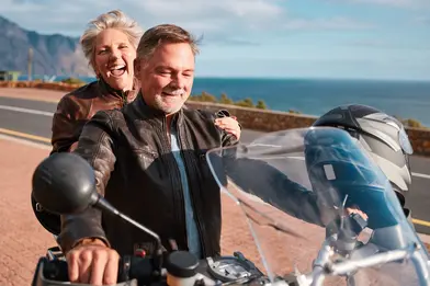 Retired couple enjoying a motorcycle ride together