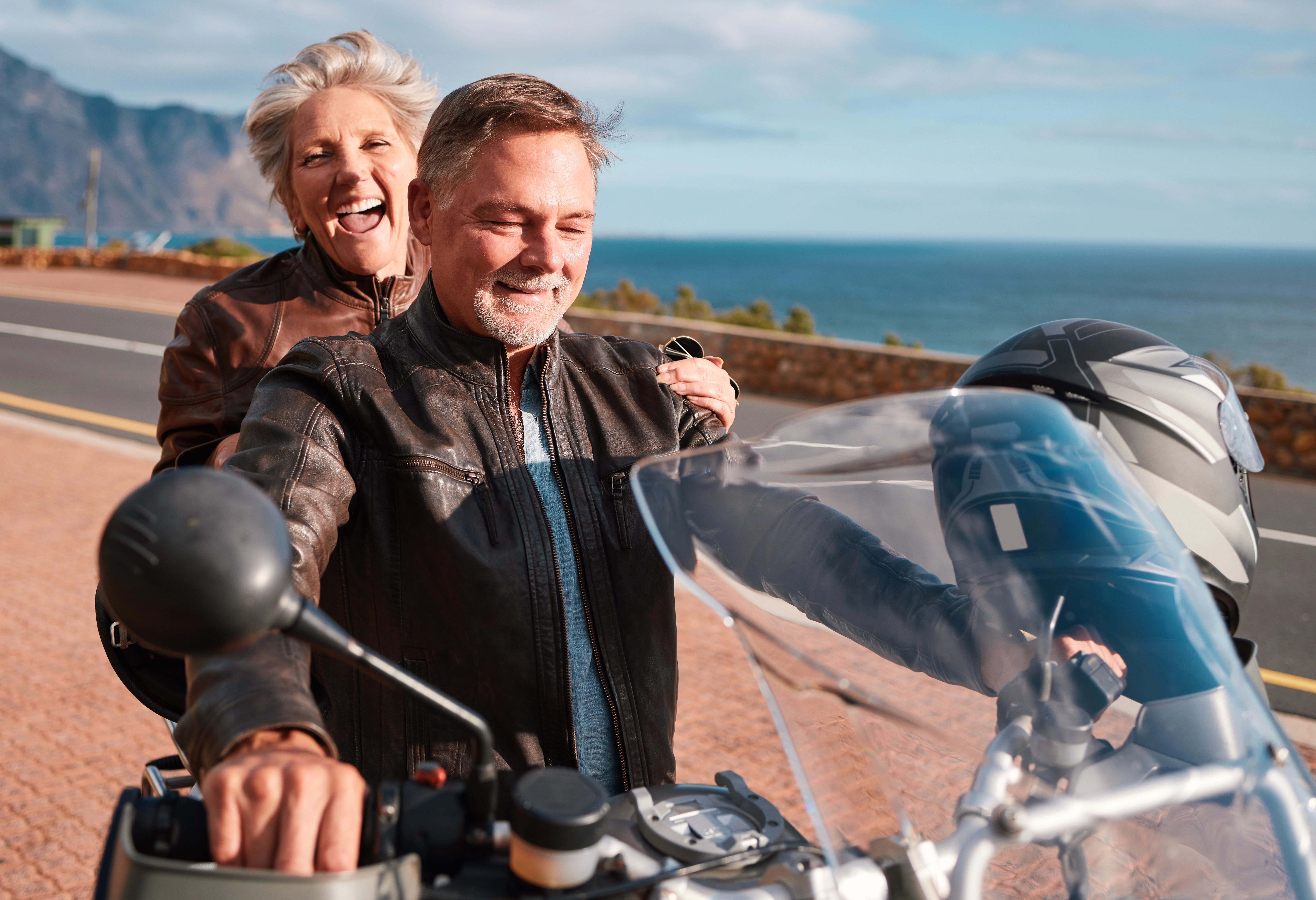 Retired couple enjoying a motorcycle ride together