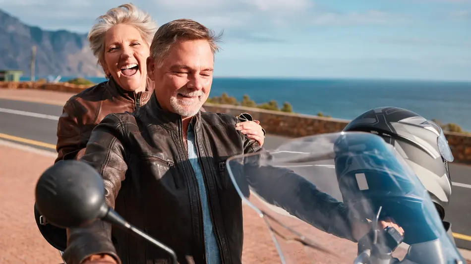 Retired couple enjoying a motorcycle ride together
