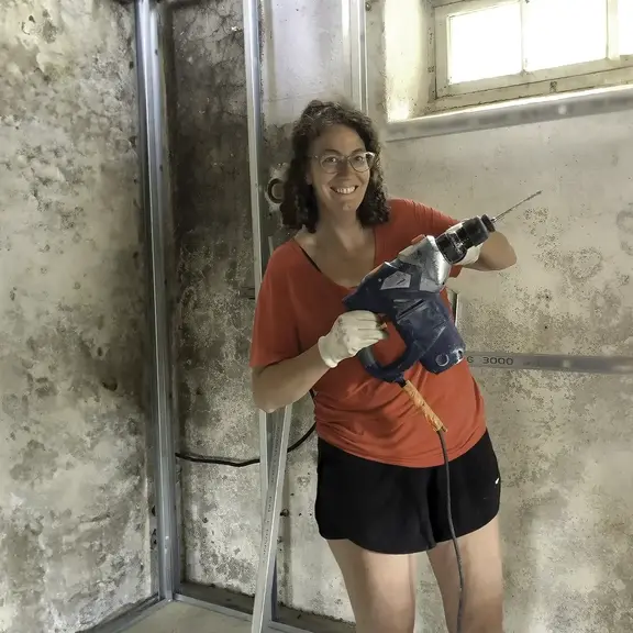 woman with a drill during a home renovation using HELOC funds
