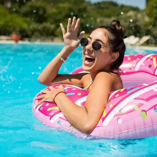 Woman enjoying pool in sunny weather image