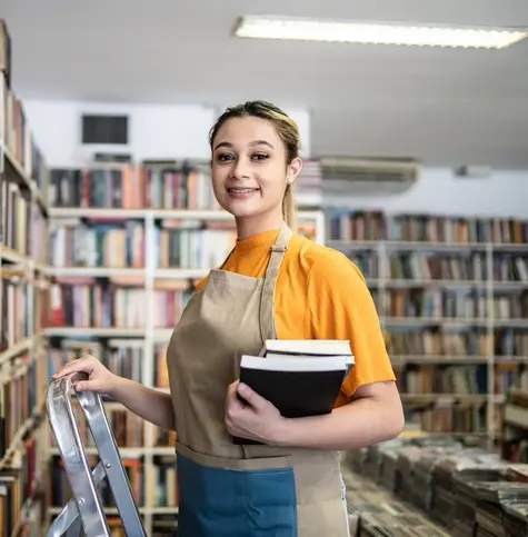 Teen girl working at library