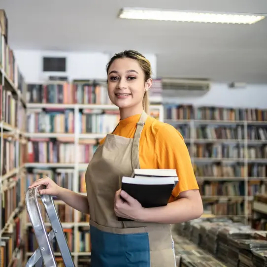 Teen girl working at library