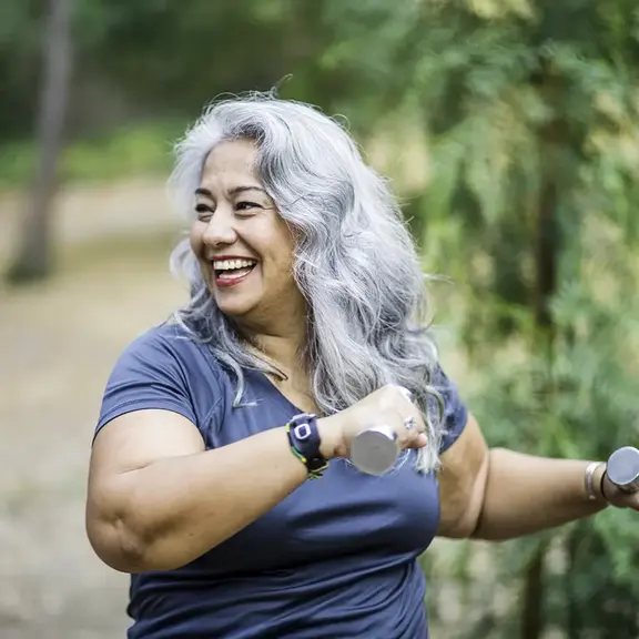 woman exercising with weights she bought from saving from her share certificate