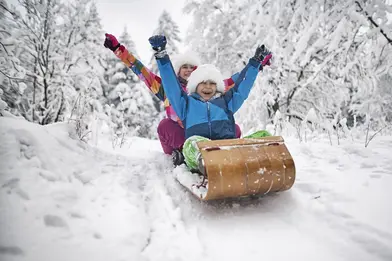 family sledding during winter