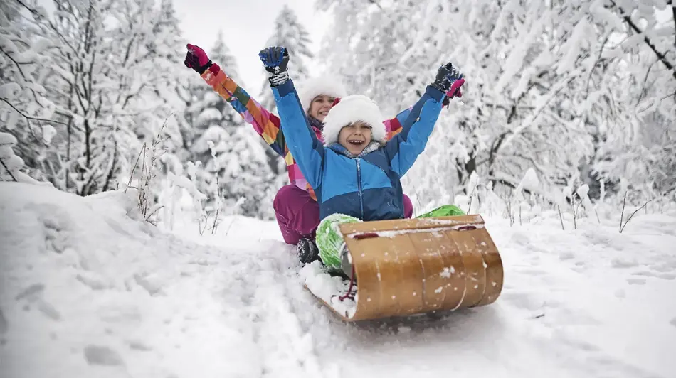 family sledding during winter