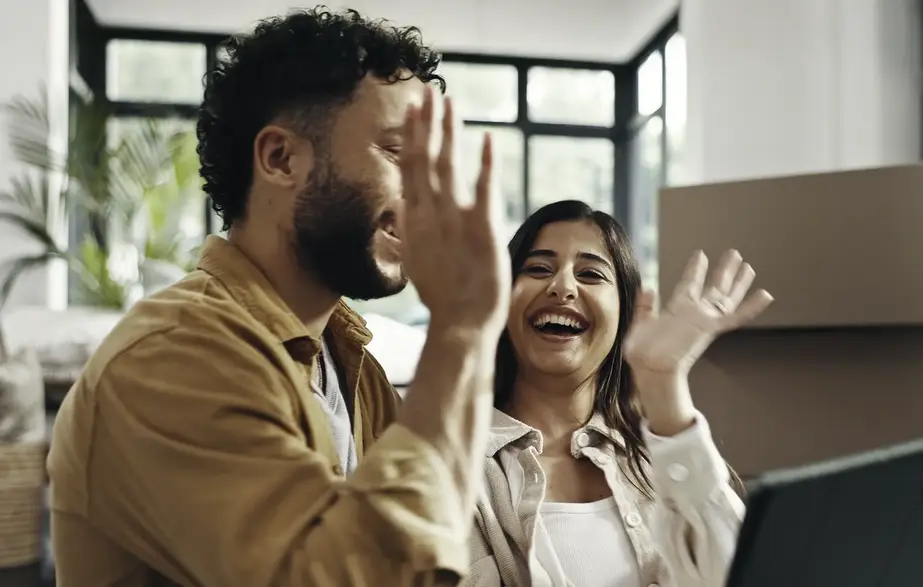 couple house high five happy to be pre-qualified for everwise mortgage