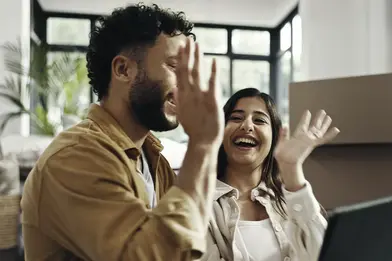 couple house high five happy to be pre-qualified for everwise mortgage