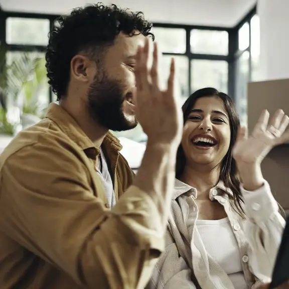 couple house high five happy to be pre-qualified for everwise mortgage