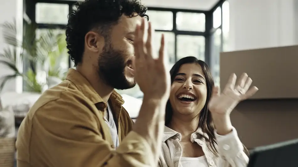 couple house high five happy to be pre-qualified for everwise mortgage