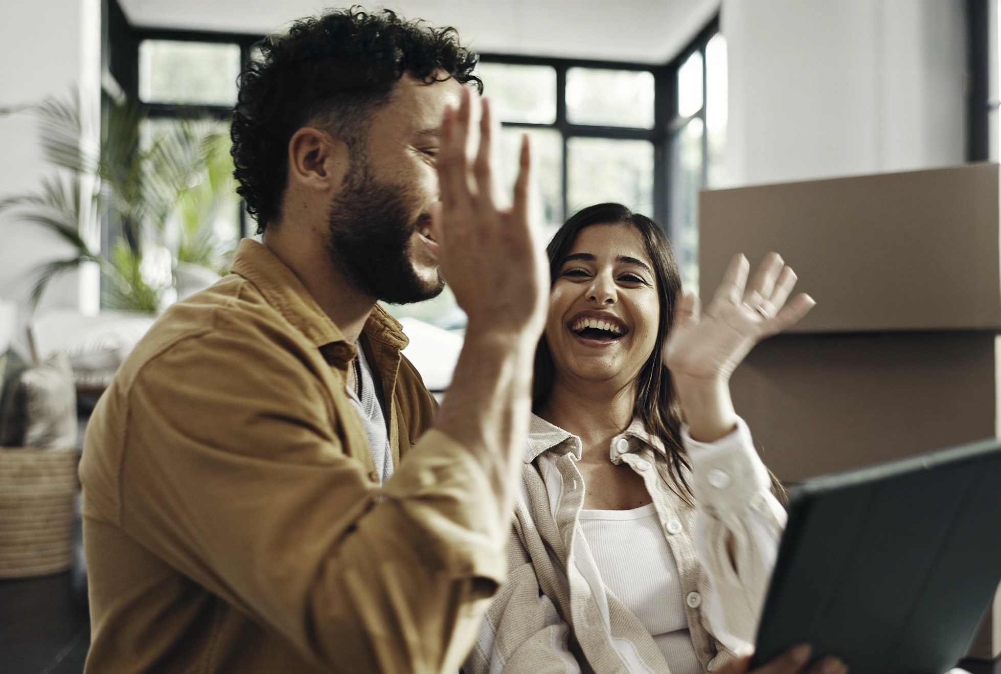 couple house high five happy to be pre-qualified for everwise mortgage