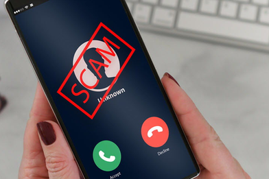 Image of a woman's hands holding a cell phone with an incoming call and the word "Scam" overlaying the screen