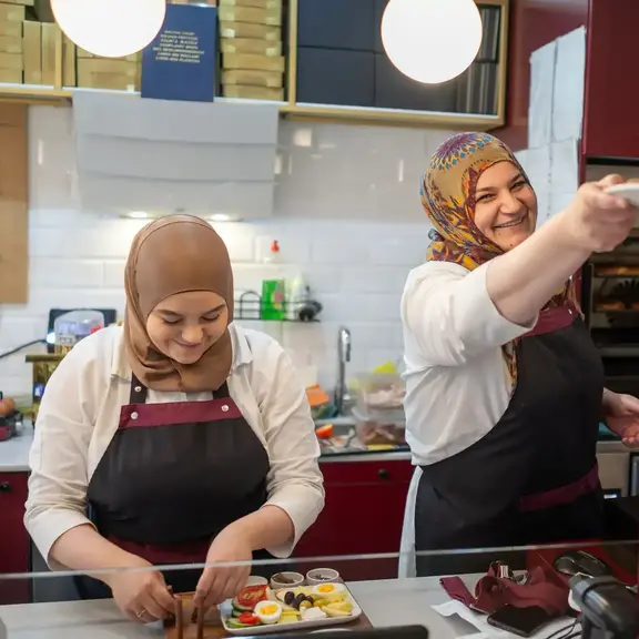 Two muslim women running a restaurant.