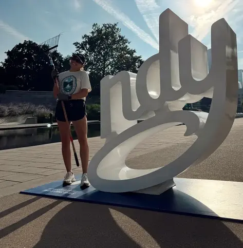 Sondra posing with Indy sign