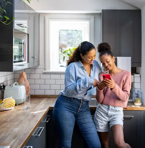 Mother and daughter bonding while watching video on social media