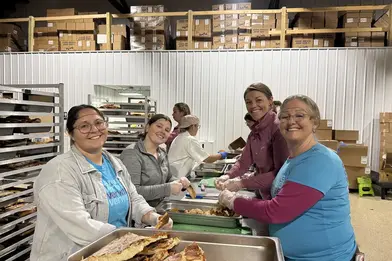 Image of Everwise employees volunteering to pack food at Cultivate South Bend during the annual Everwise Day of Giving event.