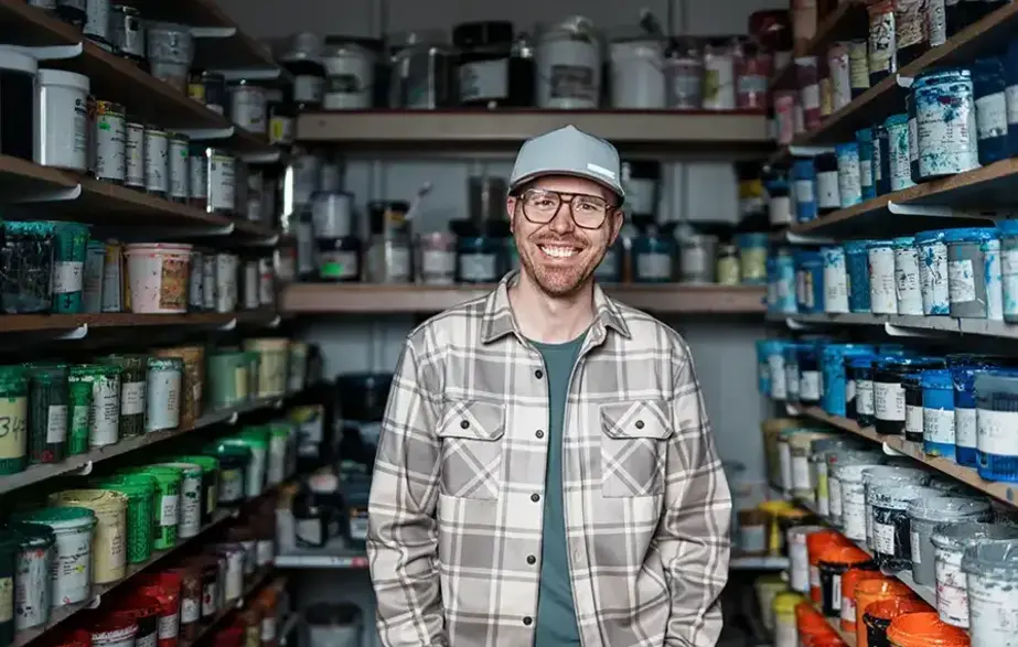 Small business owner in the paint room of his hardware store