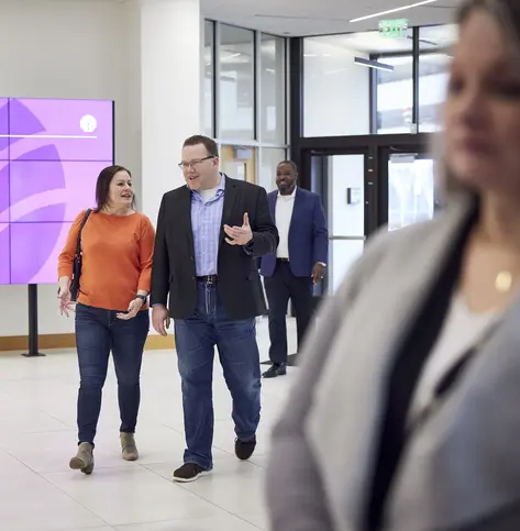 Manager and member walking through Everwise branch entry