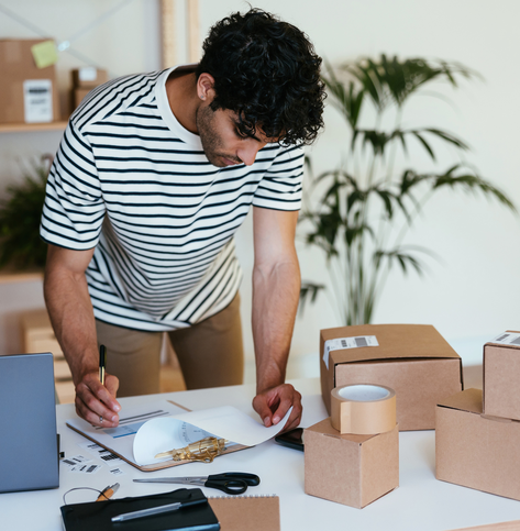 Young businessman looking over invoices. 