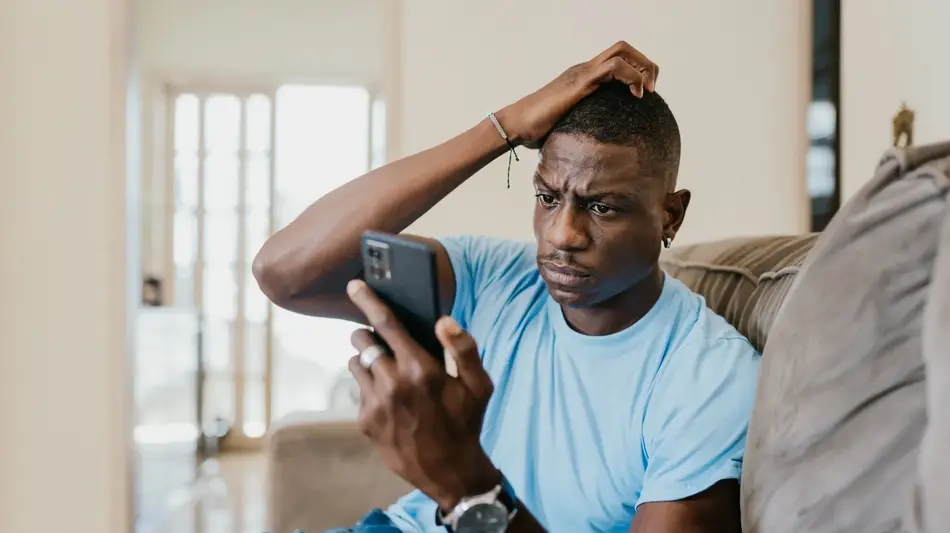 Man looking at phone concerned