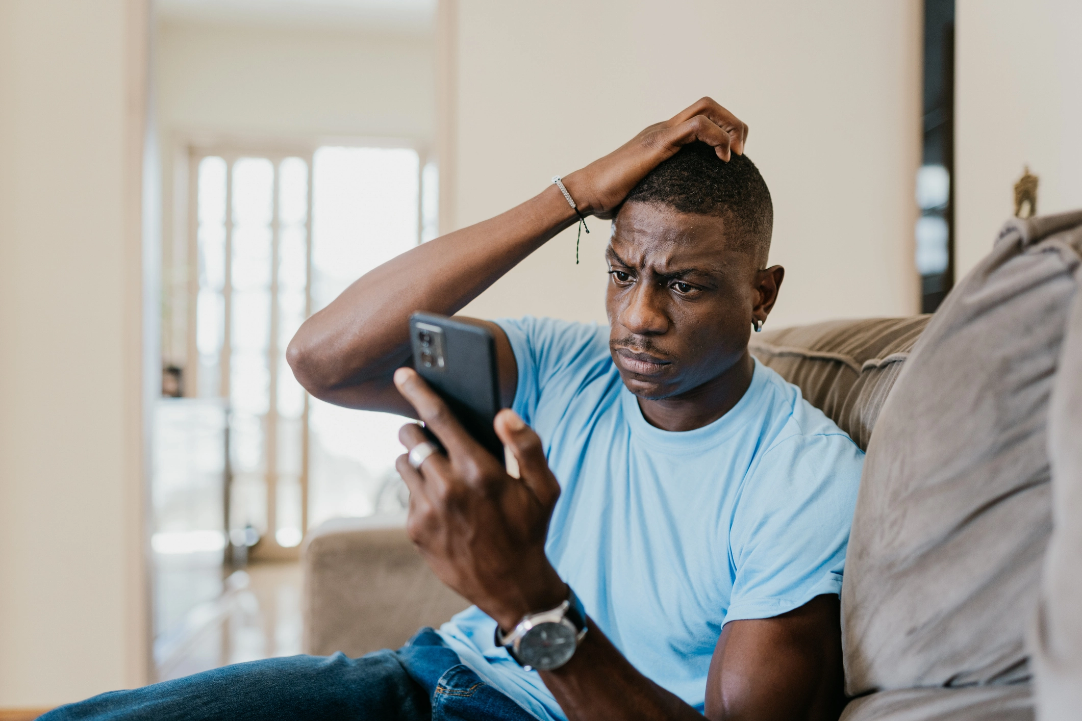 Man looking at phone concerned