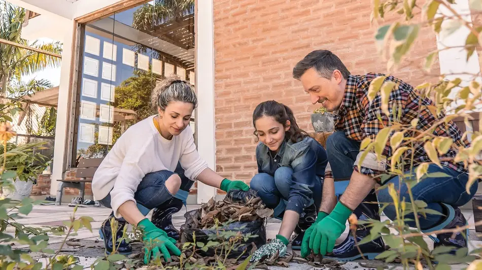 family cleaning up yard