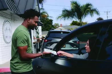 Member paying with card at Clover point-of-sale system in drive through
