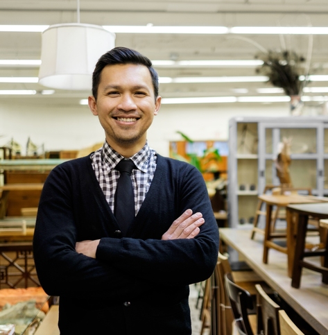 Man standing in his small furniture shop