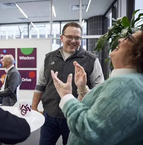 Everwise coworkers laughing and talking.