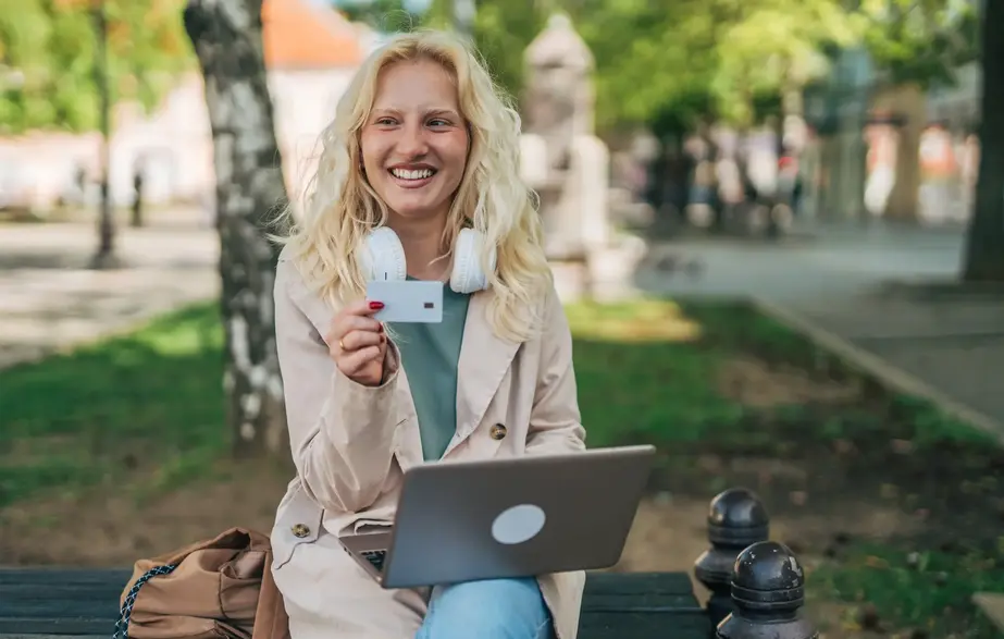 member witting with laptop and credit card