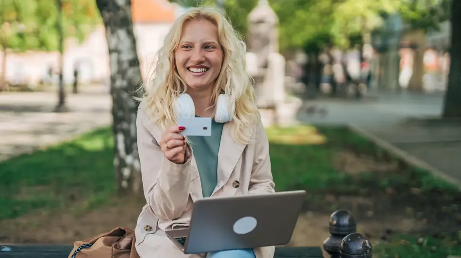 member witting with laptop and credit card