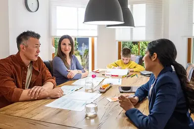 family at a table planning a budget