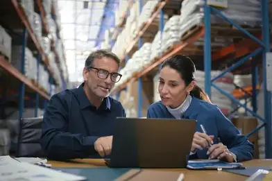 business owners with their laptop in warehouse