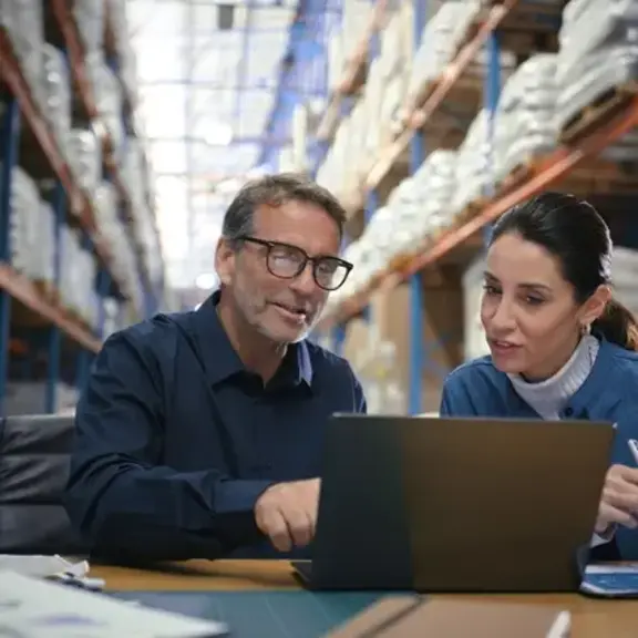 business owners with their laptop in warehouse