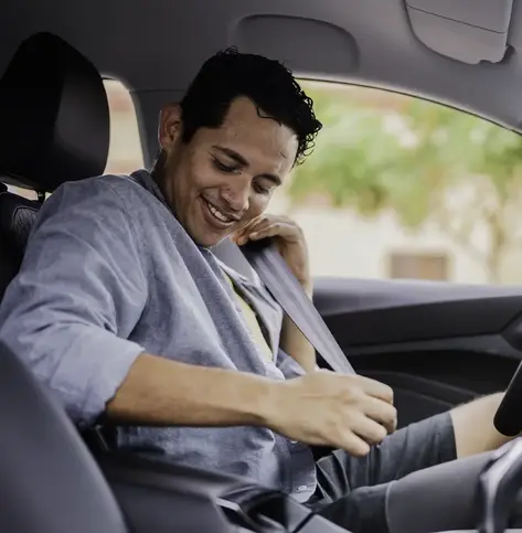 man buckling up in car safety