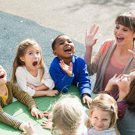 School employee smiling in a classroom setting