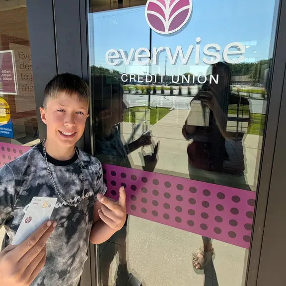 New Everwise member showing off new debit card