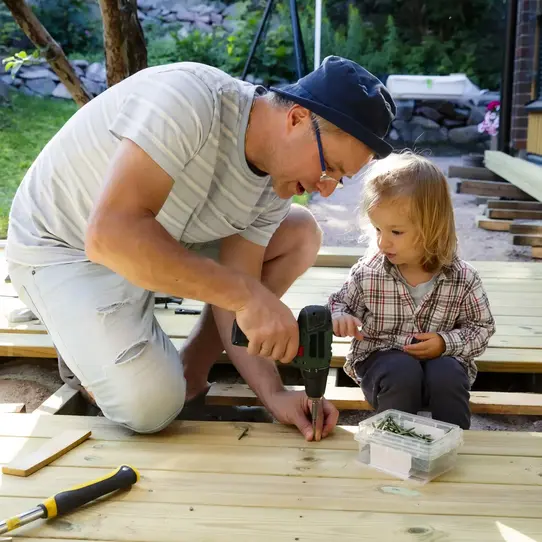 father and daughter working on deck
