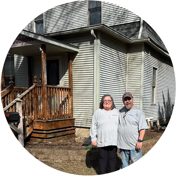 Adam and family in front of home