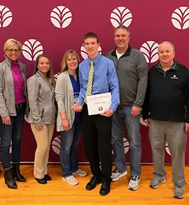 Caden Large and his family pose with Everwise staff